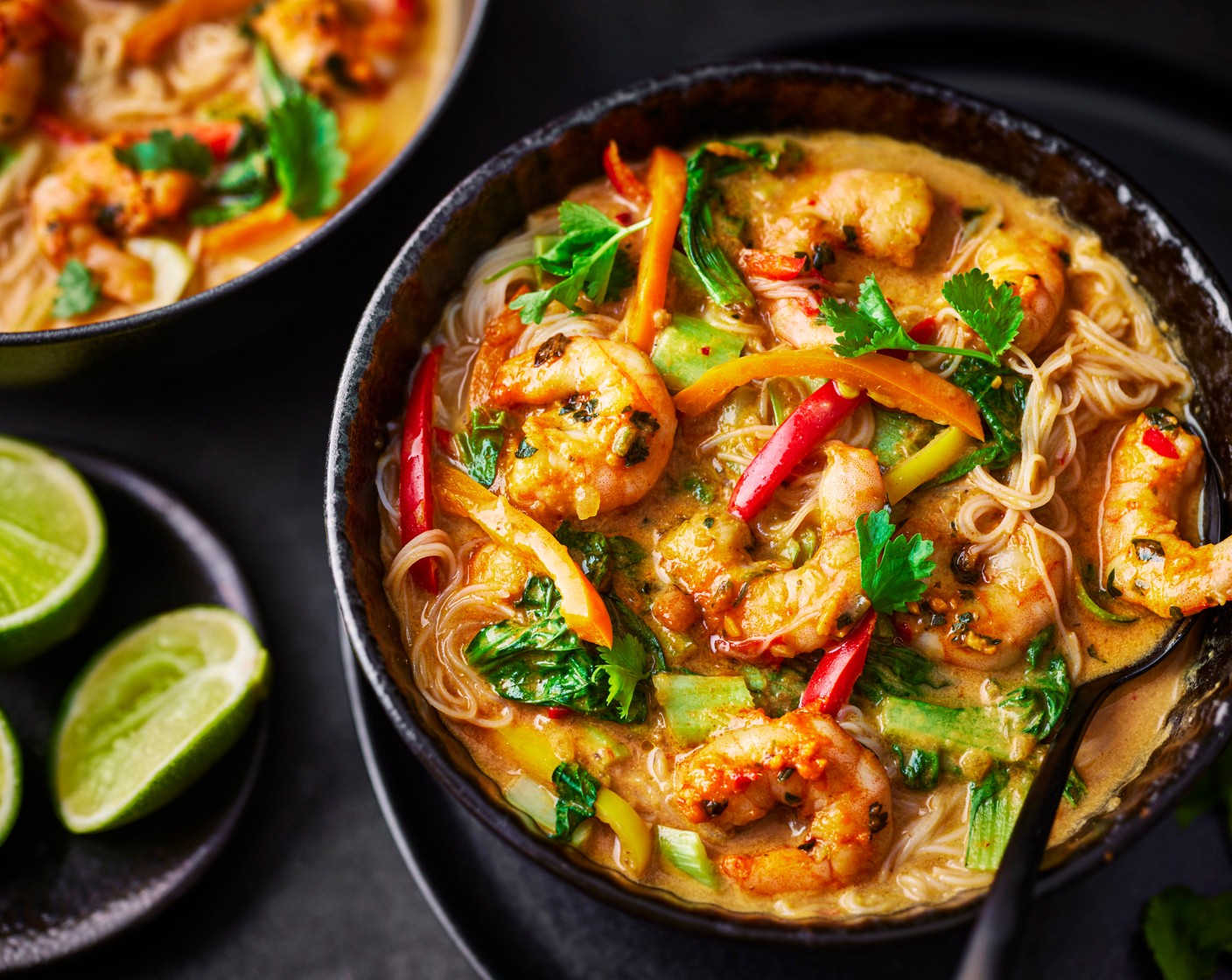 step 3 Spoon the noodles into shallow bowls then top with the broth, veg and prawns. Cut the remaining lime (1/2) into wedges and serve alongside. Finish with a scattering of fresh coriander (5 g).