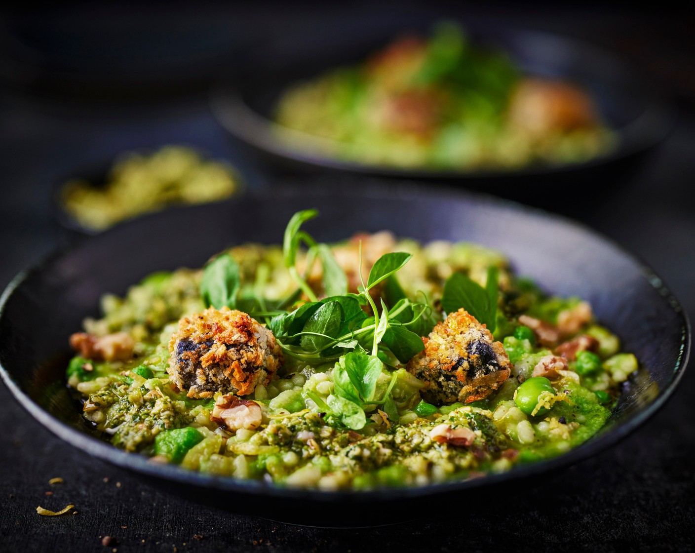 step 8 Serve the risotto in bowls, topped with the black pudding and a drizzle of pesto, a scattering of walnuts, pea shoots and lemon zest scattered over to finish.
