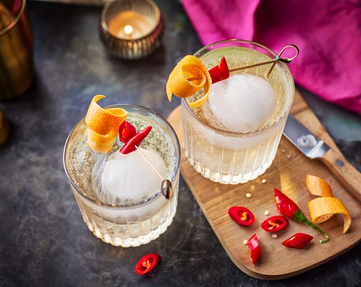 step 1 Add the ice (1) to the glass. Pour over the grapefruit and chilli Collins (1 tin), add the curl of grapefruit (1 slice) (peeled with a speed peeler and twisted round a pencil) to the top, then scatter the chillies (3 slices) on top.