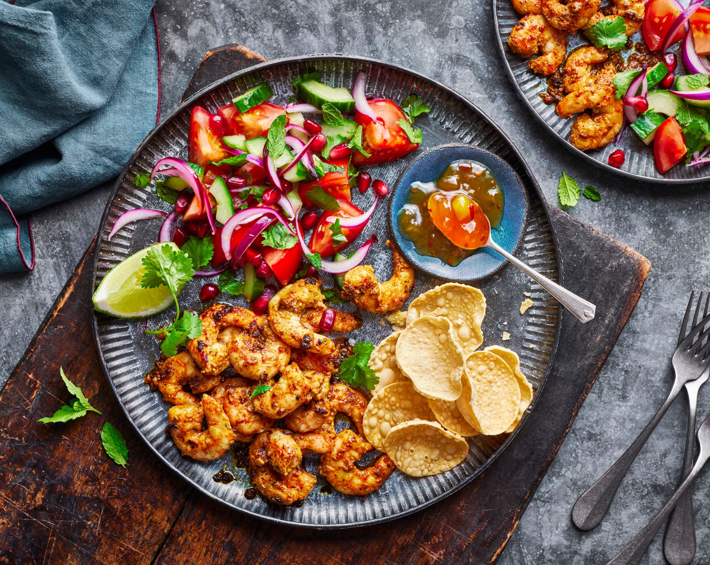 step 5 Serve the prawns with the salad, poppadom (as needed), lime (1) wedges and a generous dollop of mango chutney (as needed).