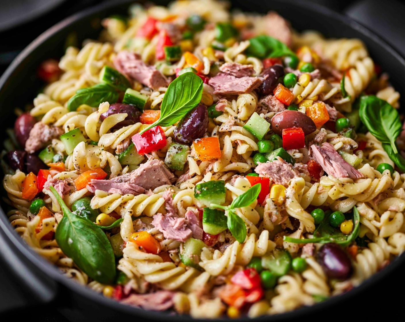 step 4 Add the cooled pasta, peas and sweetcorn, and stir through the basil (25 g). Stir in the kalamata olives (100 g) and serve straight away or pack for a lunchbox or picnic.