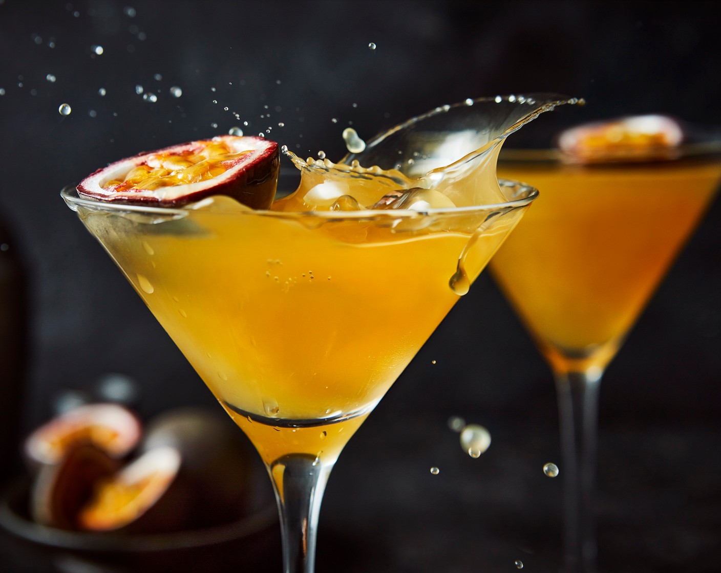 step 2 Pour the mix into two chilled martini glasses, then top up with prosecco (as needed). Top each with the remaining halved passion fruit (1).