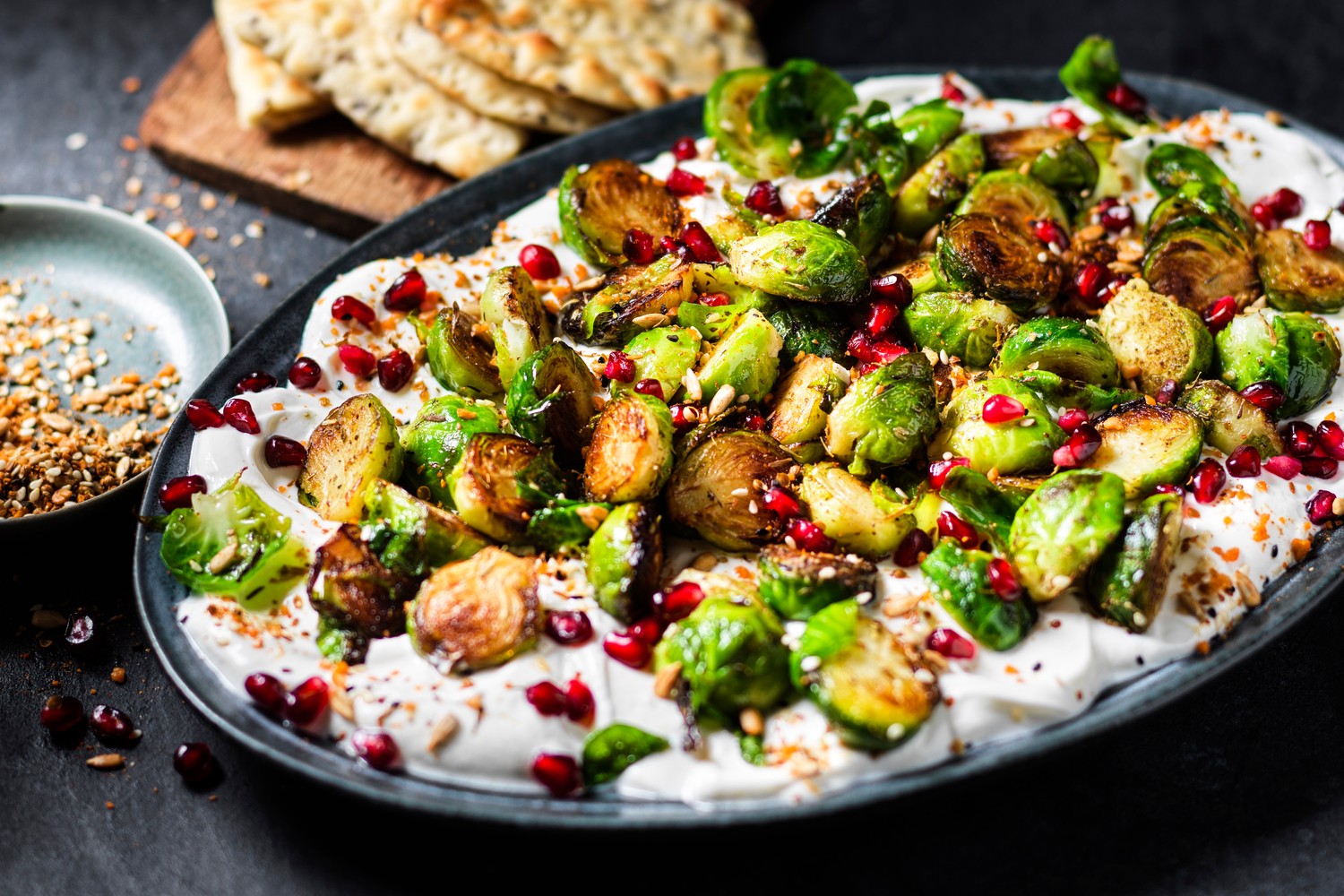 Za’atar Brussels sprouts with garlic yogurt, pomegranate and dukkah