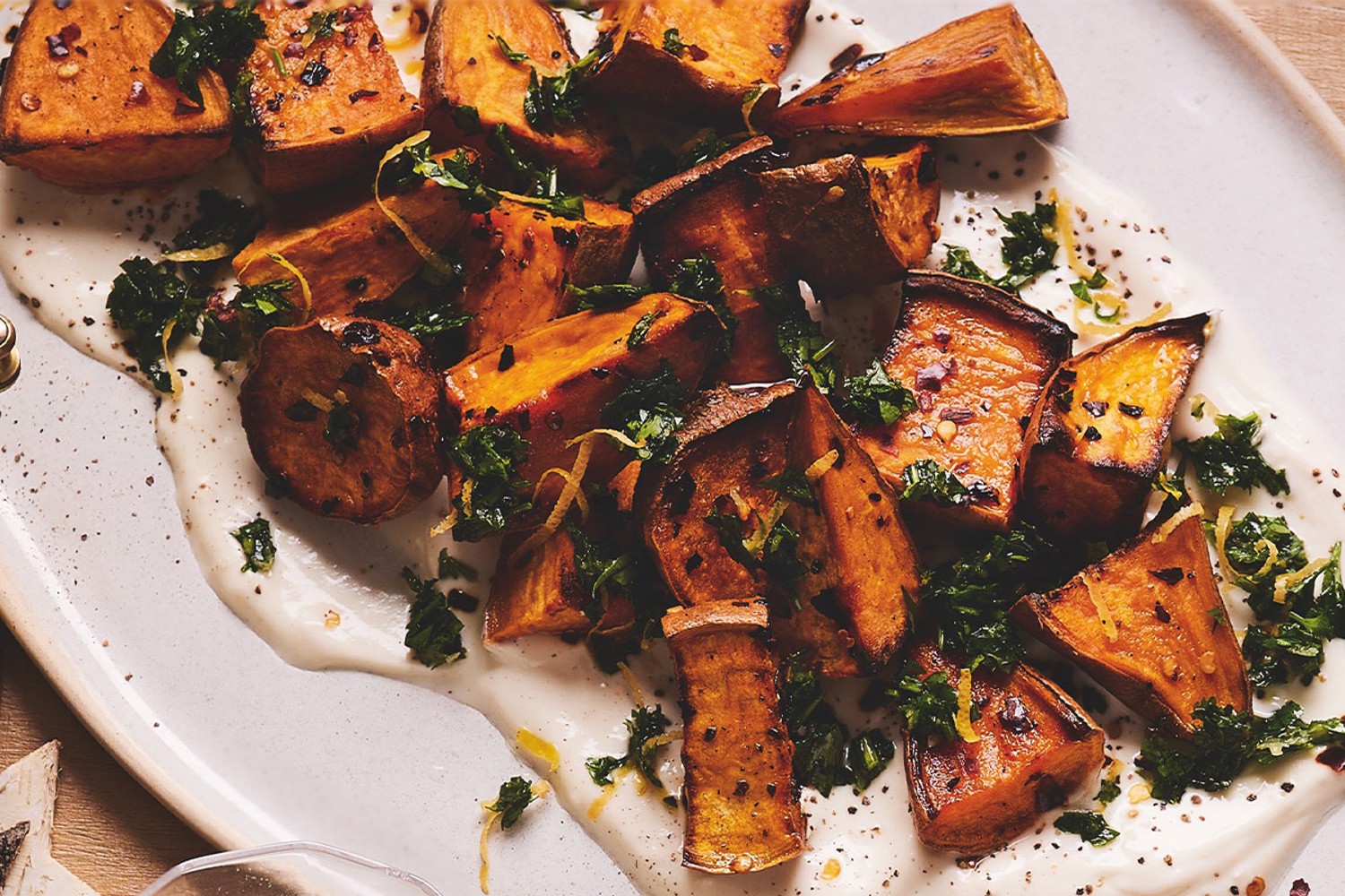 Roasted sweet potatoes with herby smash and yogurt dressing