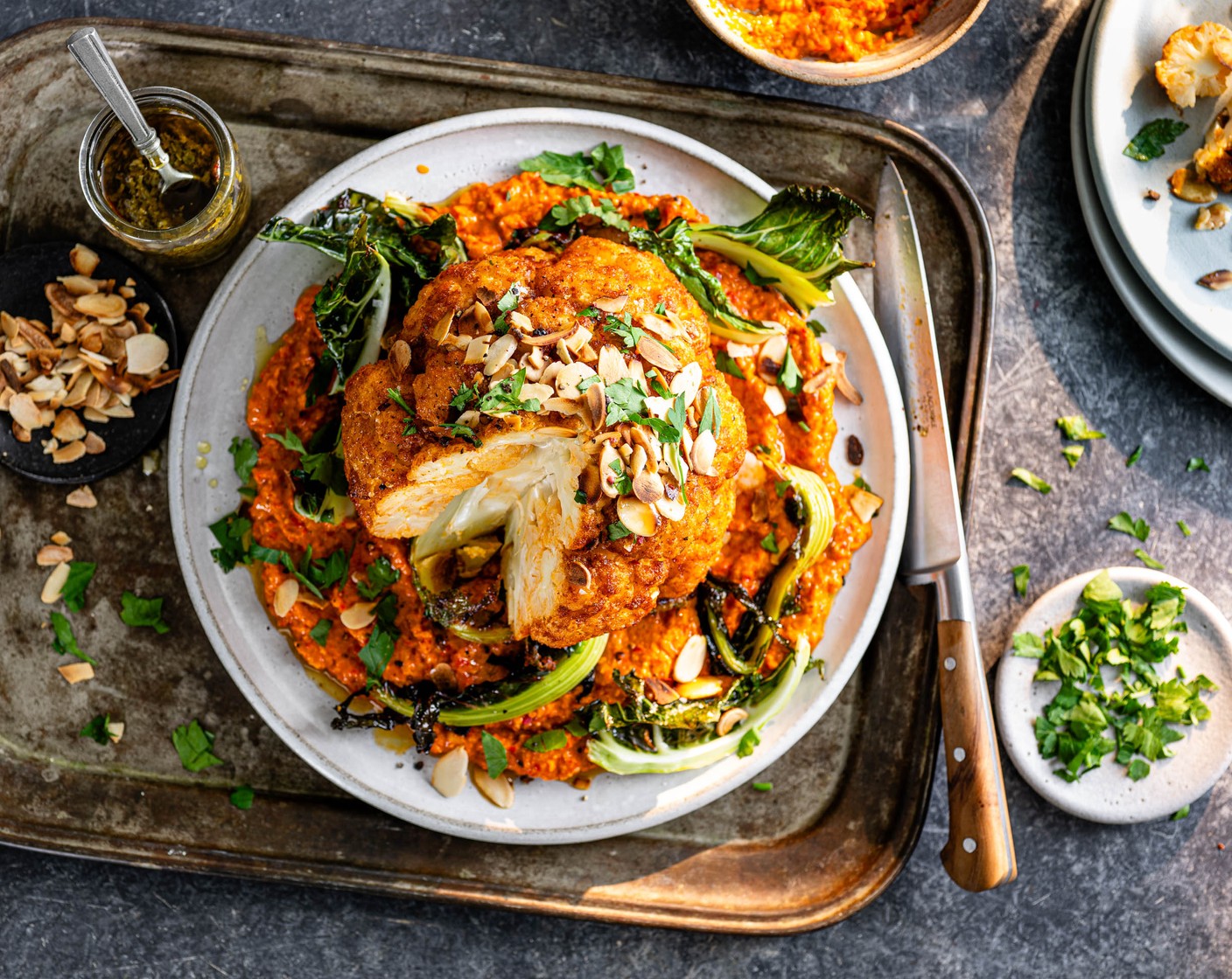 step 7 Spread the romesco onto a serving plate and top with your roasted cauliflower. Garnish with flaked almonds (1 handful), parsley (1 handful) and chimichurri (4 tbsp).