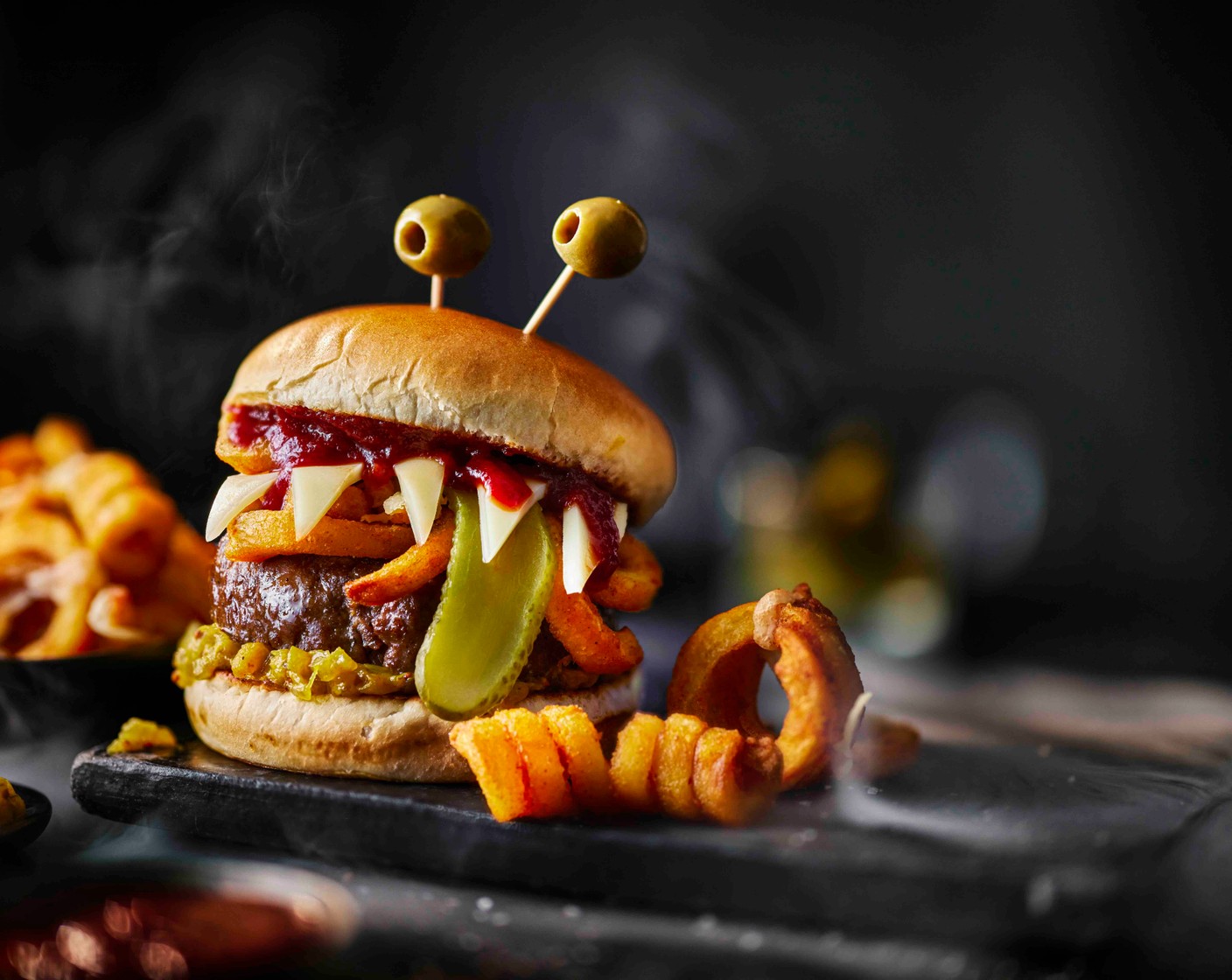 step 6 Place the bun lids on top and serve with the remaining cheesy curly fry worms alongside.