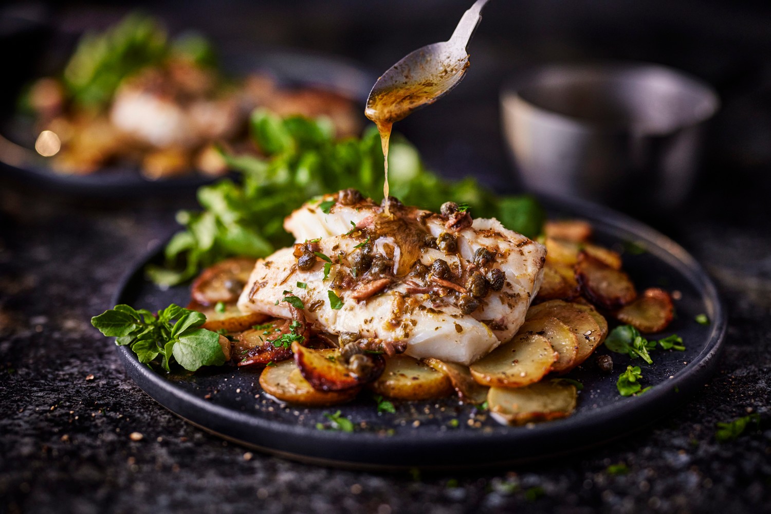 Cod traybake with new potatoes and garlicky anchovy butter recipe