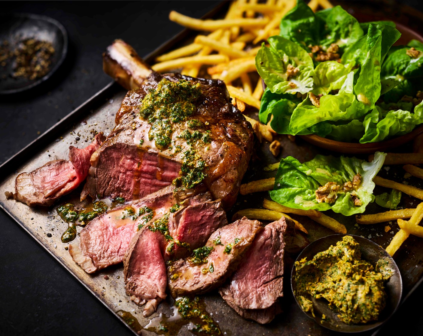 step 9 Serve the carved steak with the fries and salad, with a spoonful of the warm herb butter.