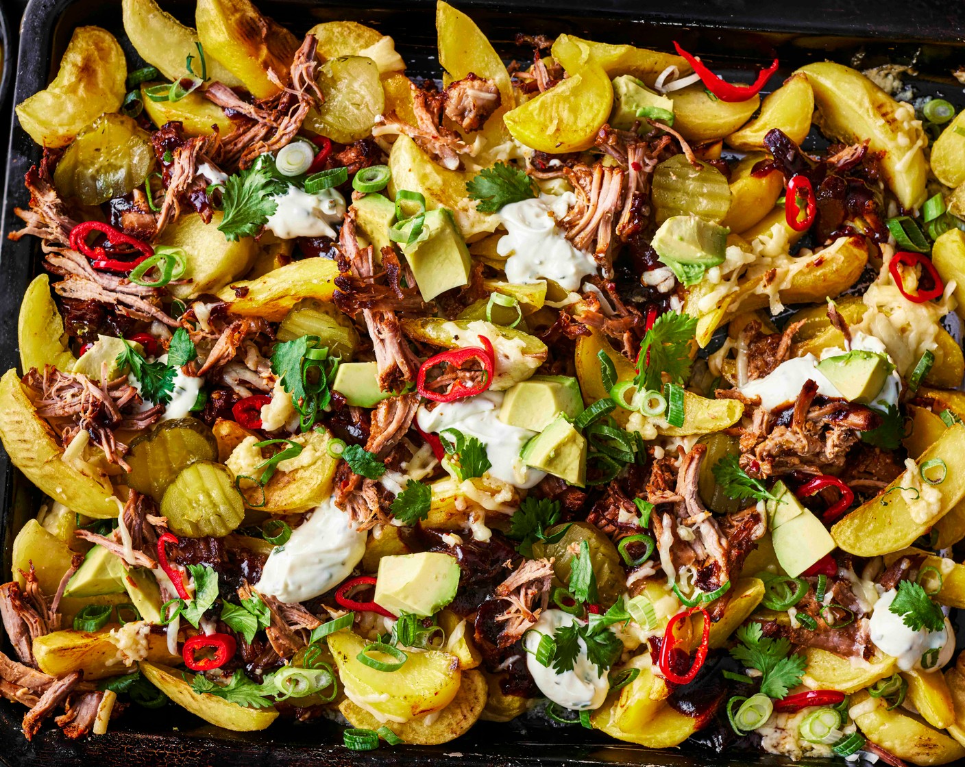 step 5 Dollop over the sour cream and chive dip (100 g), then scatter with the spring onions (4), avocado (1/2), coriander (1 handful), chilli (1) (if using) and gherkins (as needed) and then serve immediately.