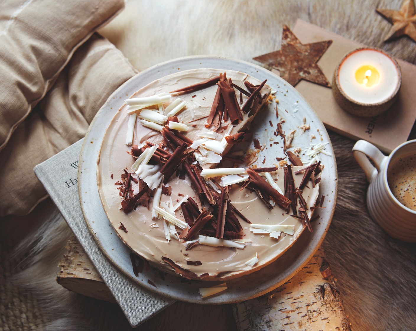 step 4 Once set, remove from the tin and top with shavings of the milk, dark or white chocolate (70 g), or all three.