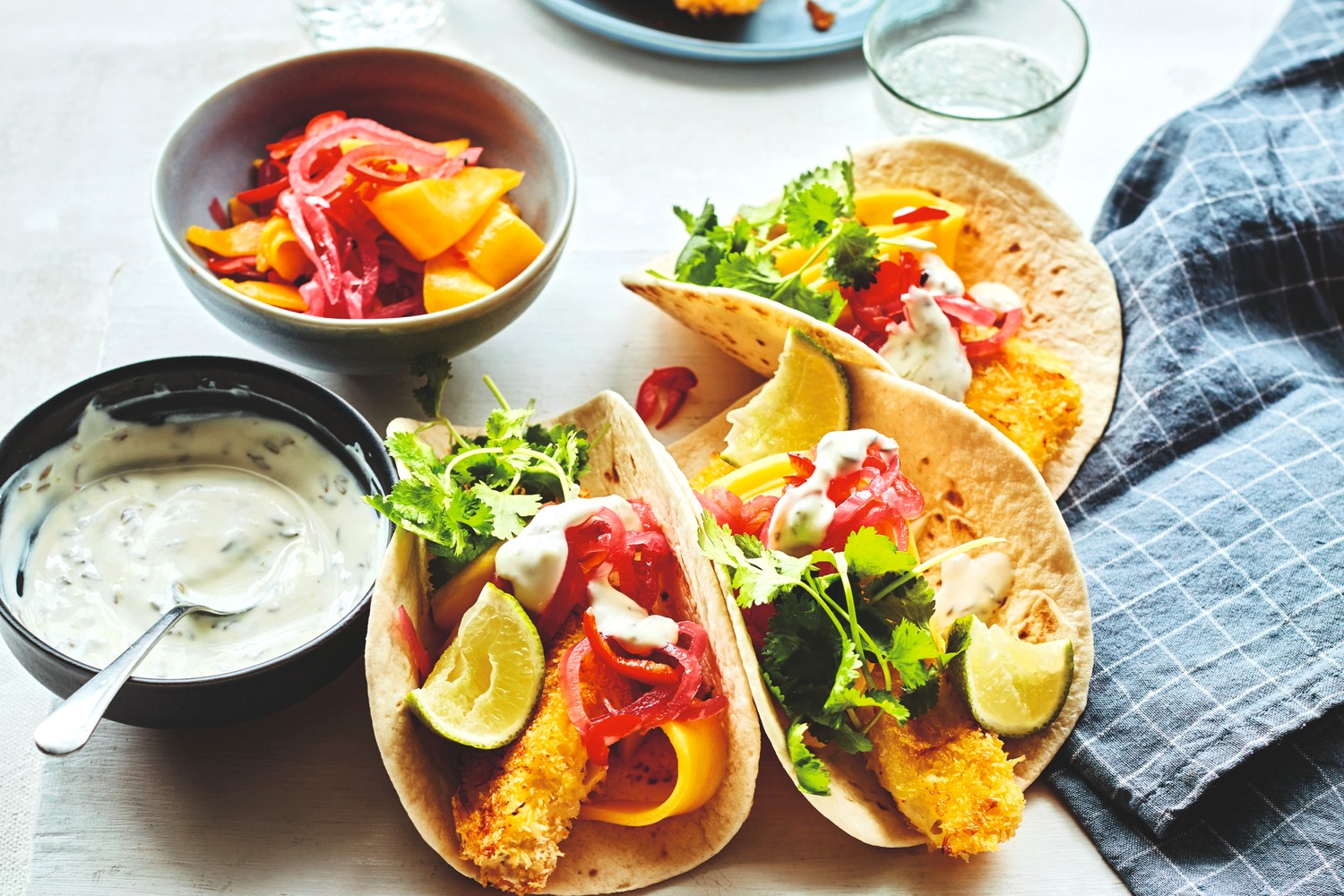 Coconut-crusted haddock goujons with soft tacos and zingy mango salsa