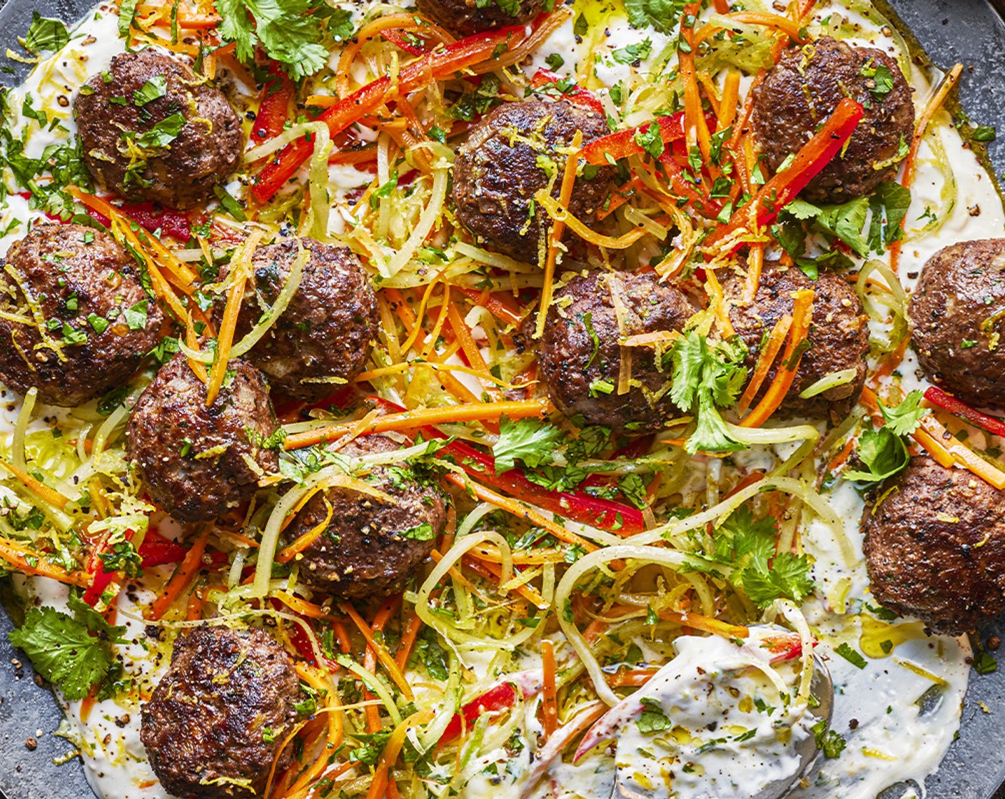 step 7 To serve, spread the labneh out onto a platter and top with the meatballs and a little of the slaw, serving the rest on the side.