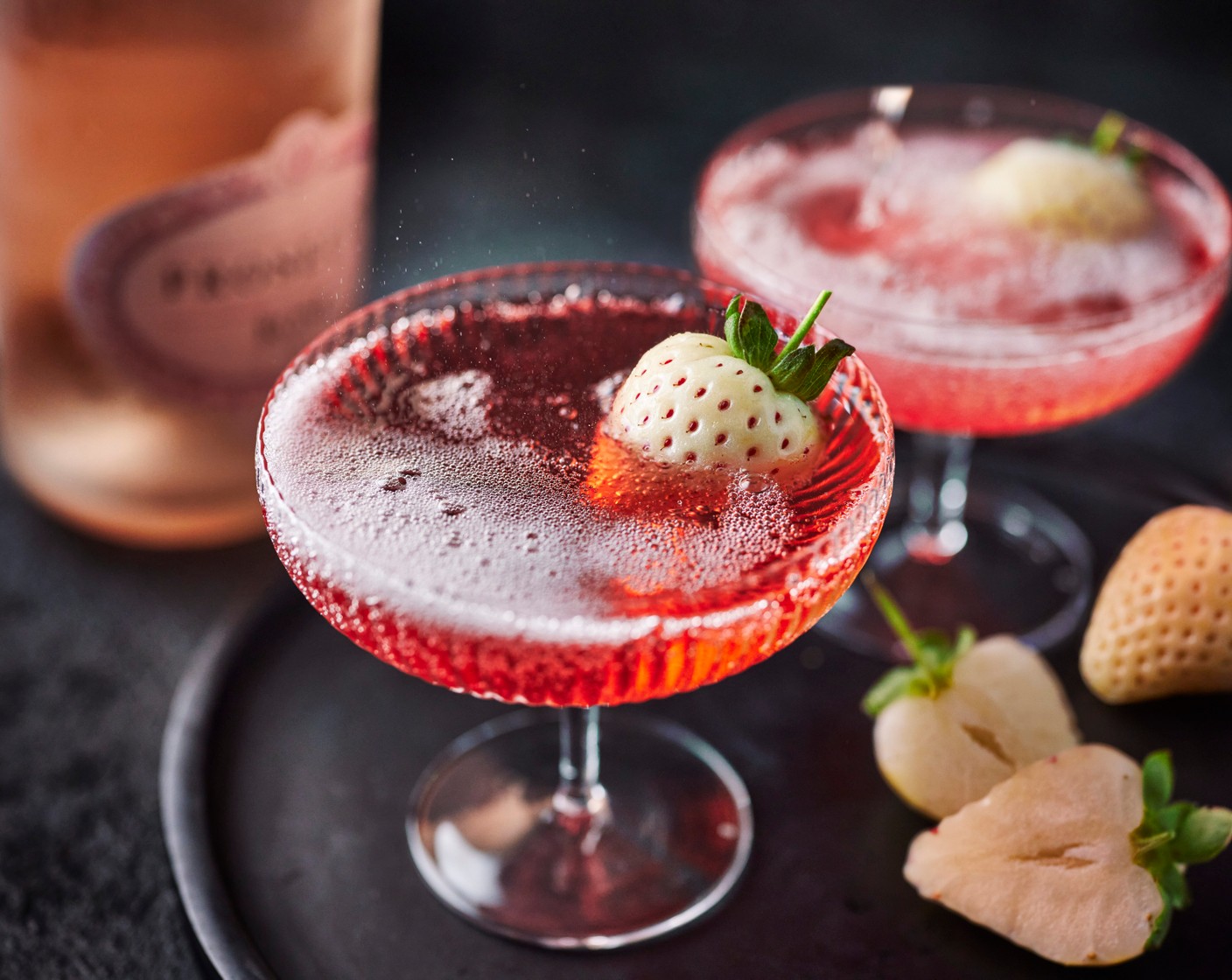 step 1 Pour the liqueur (60 ml) into two champagne coupés. Top up with the prosecco (200 ml) and garnish with a cut strawberry (1).