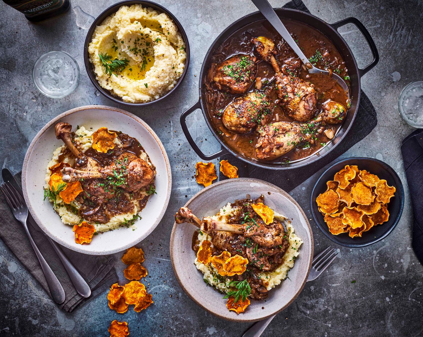 step 9 To serve, spoon the mash into the centre of a shallow platter or individual plates. Top with a few chicken drumsticks and drizzle the sauce around the mash. Finish with the sweet potato crisps, blanched cauliflower leaves, reserved florets and carrot tops. Drizzle with a flourish of olive oil.