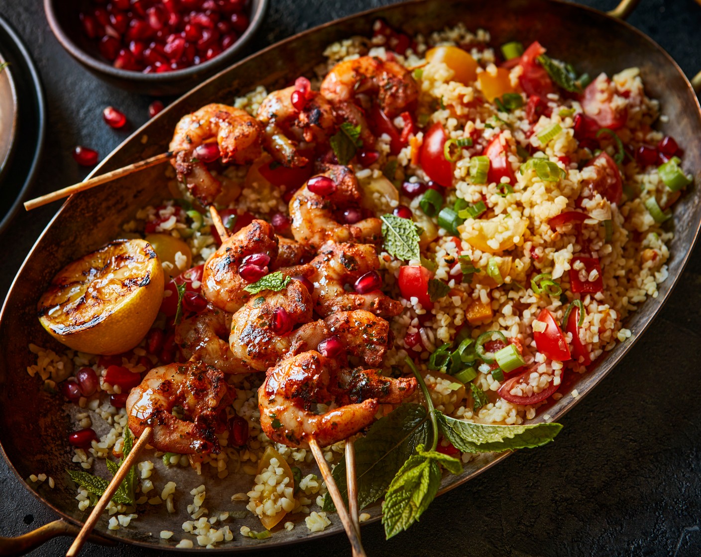 step 5 Serve the prawn skewers with the tabbouleh and a scattering of pomegranate rubies (100 g).