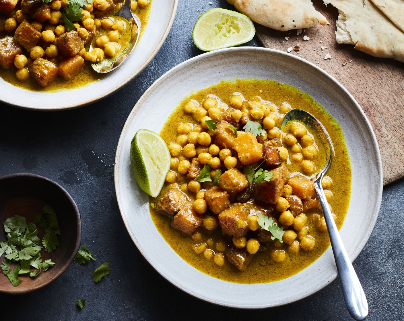 step 4 To serve, divide the chickpeas between two serving bowls, scatter over the roasted butternut squash and finish with a squeeze of limes (as needed) and some coriander (as needed). Serve with M&S bake and serve plain naan breads (as needed).