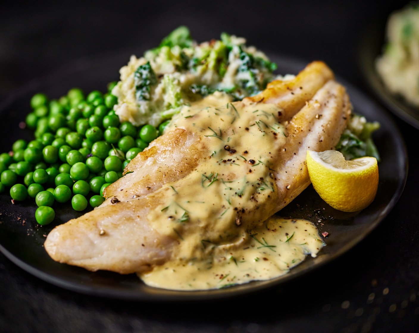 step 7 Serve the colcannon with the peas and top with the basa fillets. Finish by pouring over the dill sauce. Serve with the lemon wedges (1).