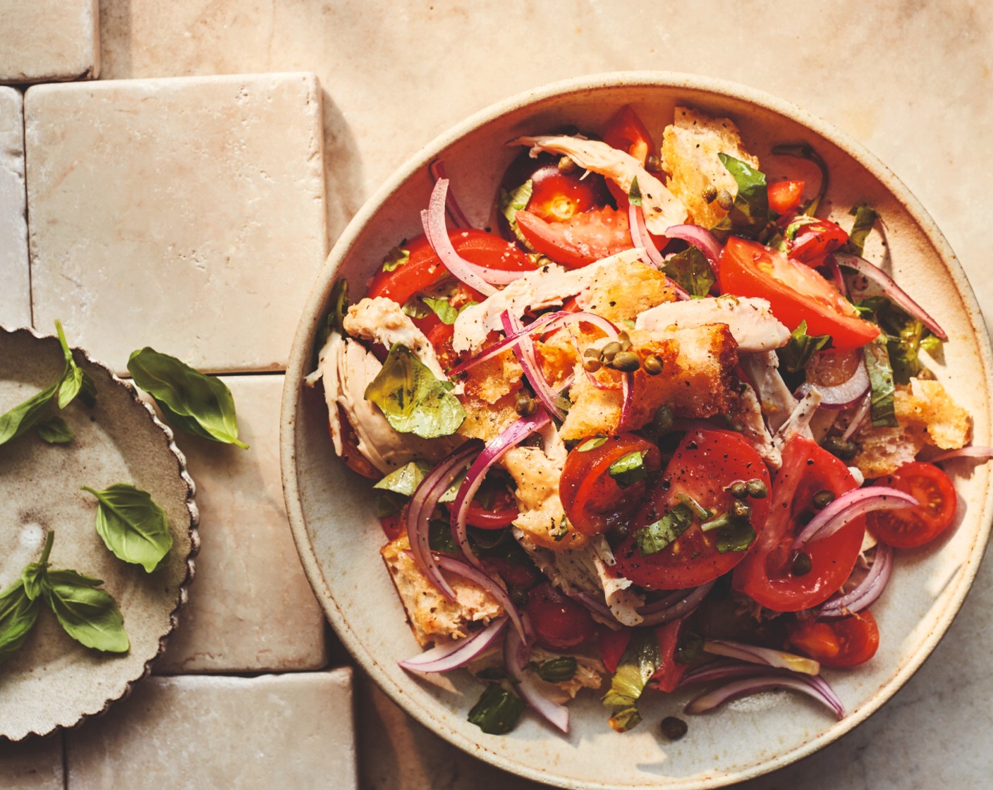 step 4 Whisk the red wine vinegar (1 tbsp), garlic (3 cloves) and 2 tbsp extra virgin olive oil in the bowl with the tomato juices. Toss in the onion (1), basil (1 handful), capers (1 tbsp), tomatoes, toasted bread and shredded chicken. Finish with more fresh basil.